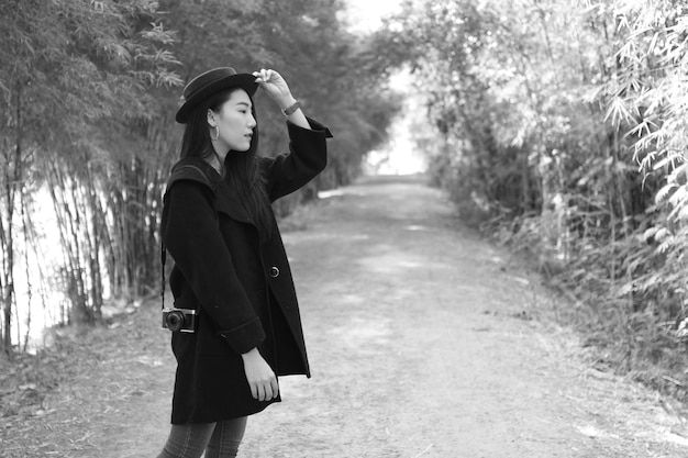 woman standing against trees