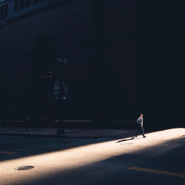 Woman walking on road at night