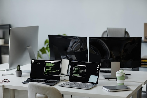 workplaces of several diversity programmers with laptops and computer monitors