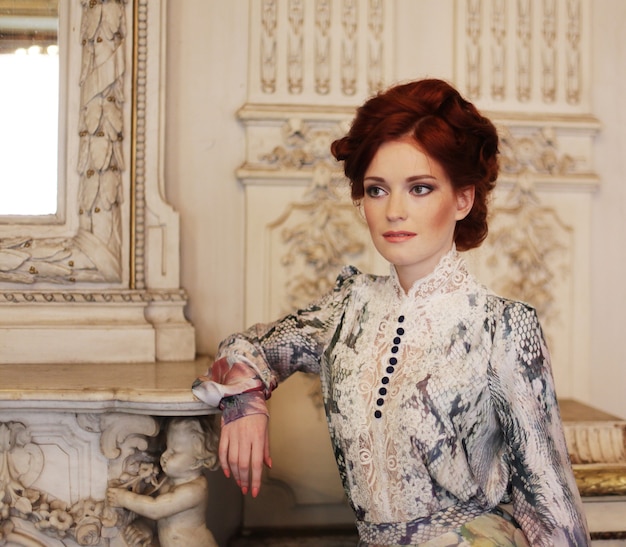 young beautiful woman standing in the palace room.
