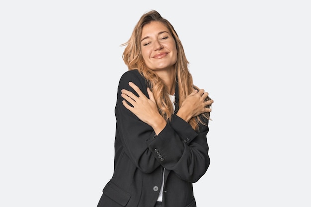 Young businesswoman in a suit hugs smiling carefree and happy
