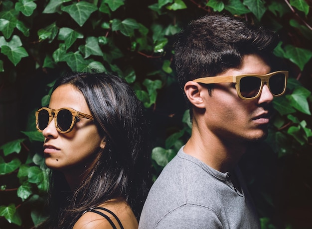 young couple wearing sunglasses against sky