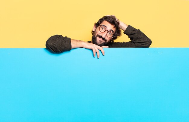 Young crazy bearded man expressing a emotion with a copy space