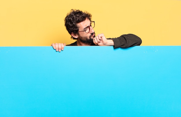 Young crazy bearded man expressing a emotion with a copy space