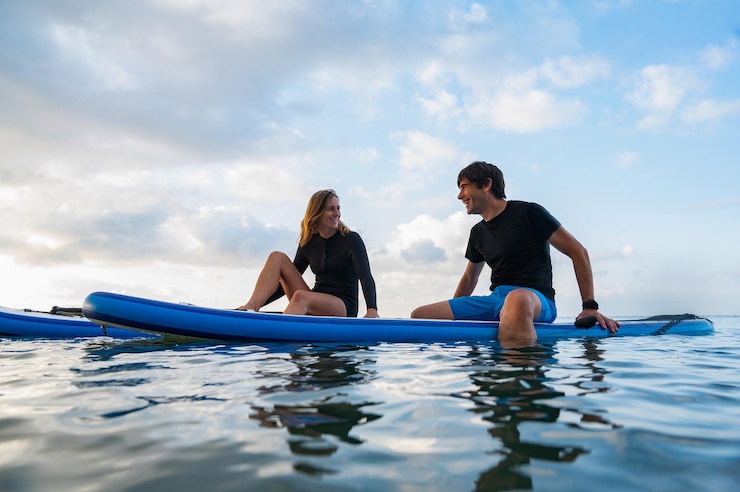 Foto young man and young woman enjoying a day of paddlesurfing