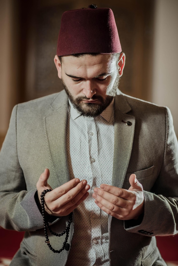Foto young man praying while sitting at mosque