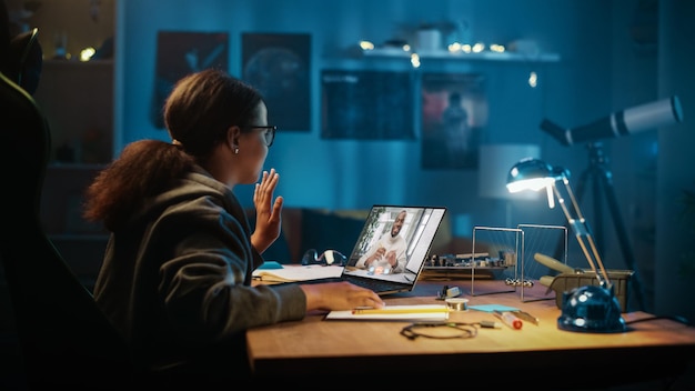 Young Teenage Multiethnic Girl Making is Participating in an Online School Lesson Attending Educational Online Class Talking to Teacher About an Exam Doing School Homework