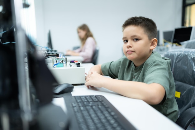 Youngsters utilizing the hand robot technology are having fun learning the electronic circuit board and hand robot controller of robot technology which is one of the STEM courses