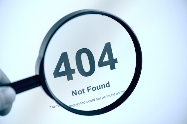 404 error internet page not found, hand with magnifier, concept picture