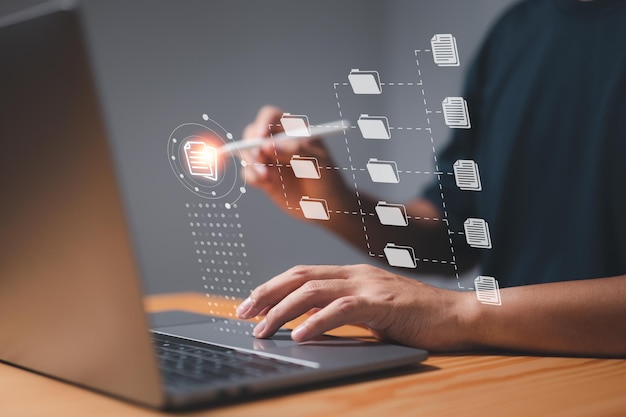 A businessman uses a computer to learn about document management concepts online documentation databases digital file storage systems database technology file access and document sharing