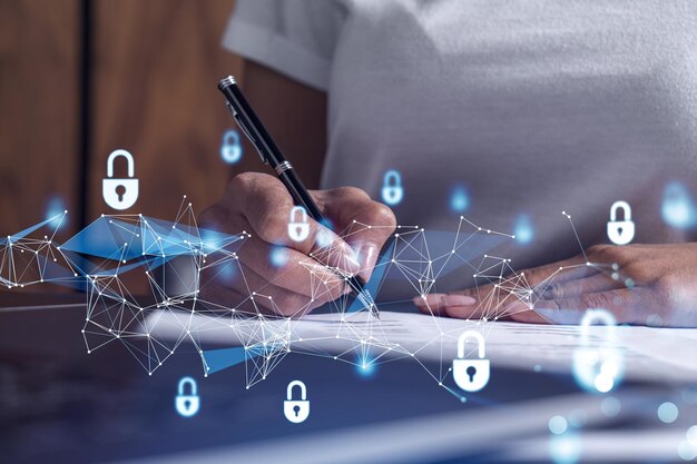 A businesswoman in casual wear signing the contract to prevent probability of risks in cyber security Padlock Hologram icons over the working desk