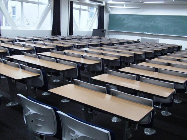 a classroom with rows of desks and chairs