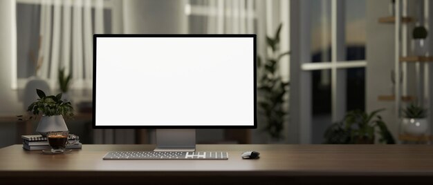 A computer desk in a contemporary minimalist room in the evening features a computer mockup