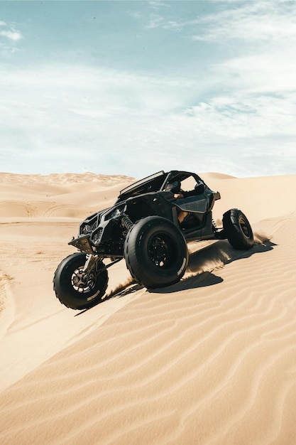 a jeep in the desert with the sky in the background