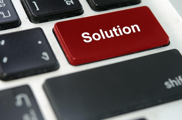 A keyboard with a red button Solution