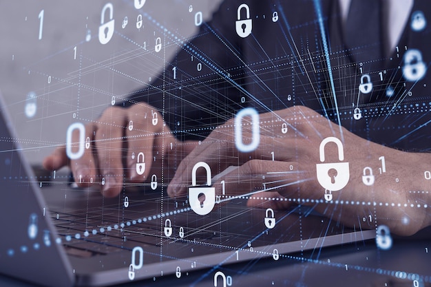 a programmer is typing a code on computer to protect a cyber security from hacker attacks and save clients confidential data padlock hologram icons over the typing hands formal wear
