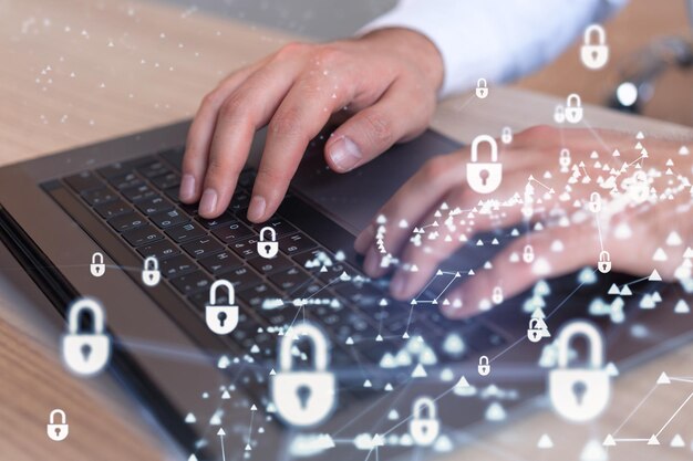 A programmer is typing a code on computer to protect a cyber security from hacker attacks and save clients confidential data Padlock Hologram icons over the typing hands Formal wear