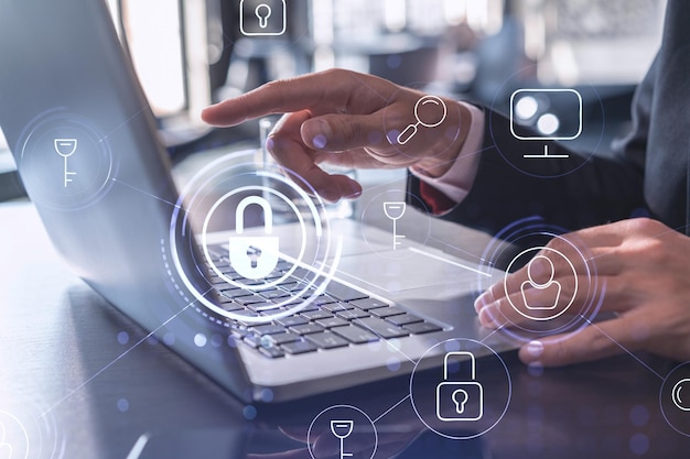 a programmer is typing a code on computer to protect a cyber security from hacker attacks and save clients confidential data padlock hologram icons over the typing hands formal wear
