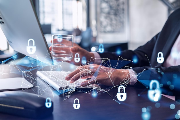 a programmer is typing a code on computer to protect a cyber security from hacker attacks and save clients confidential data padlock hologram icons over the typing hands formal wear