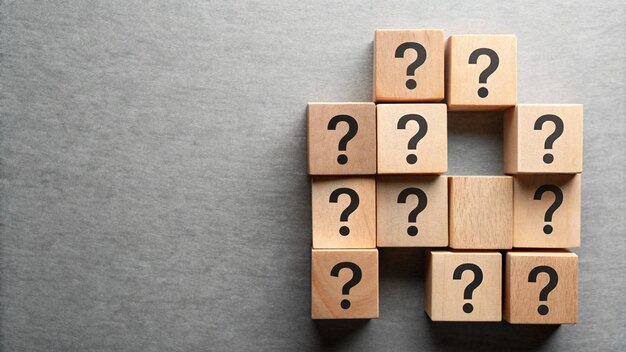 a set of wooden cubes with question marks on the top