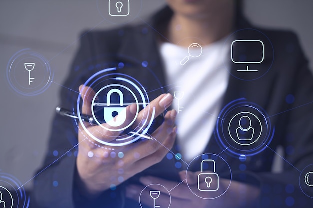 a woman programmer is browsing the internet in smart phone to protect a cyber security from hacker attacks and save clients confidential data padlock hologram icons over the typing hands formal wear