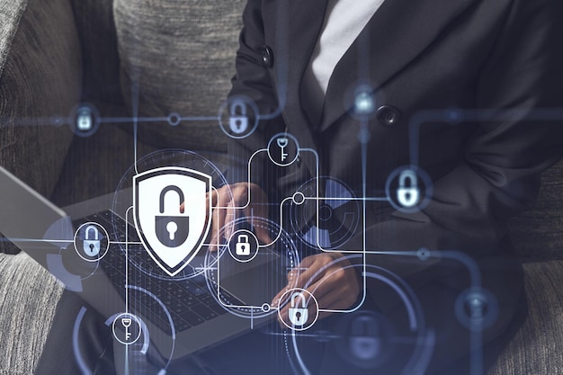 A woman programmer is typing a code on computer to protect a cyber security from hacker attacks and save clients confidential data Padlock Hologram icons over the typing hands Formal wear