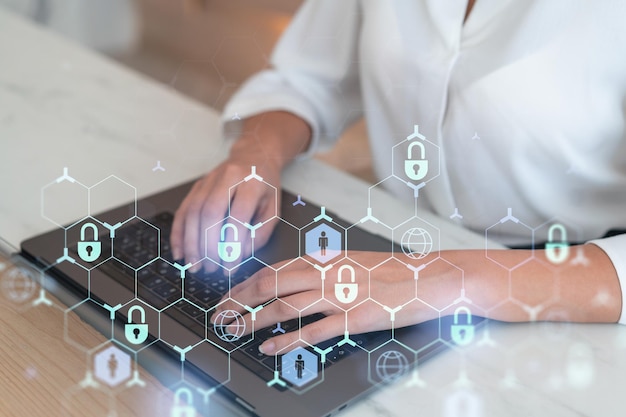 A woman programmer is typing a code on computer to protect a cyber security from hacker attacks and save clients confidential data Padlock Hologram icons over the typing hands Formal wear