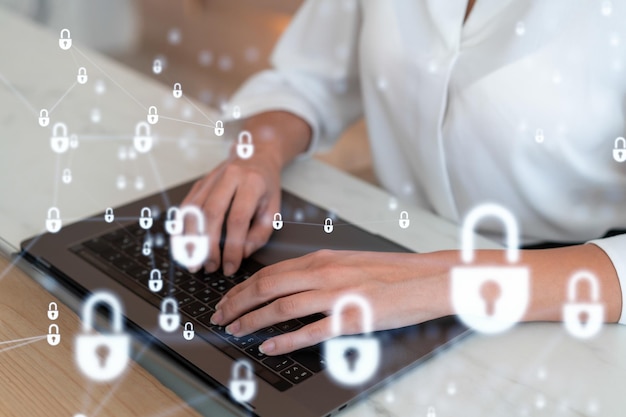 A woman programmer is typing a code on computer to protect a cyber security from hacker attacks and save clients confidential data Padlock Hologram icons over the typing hands Formal wear