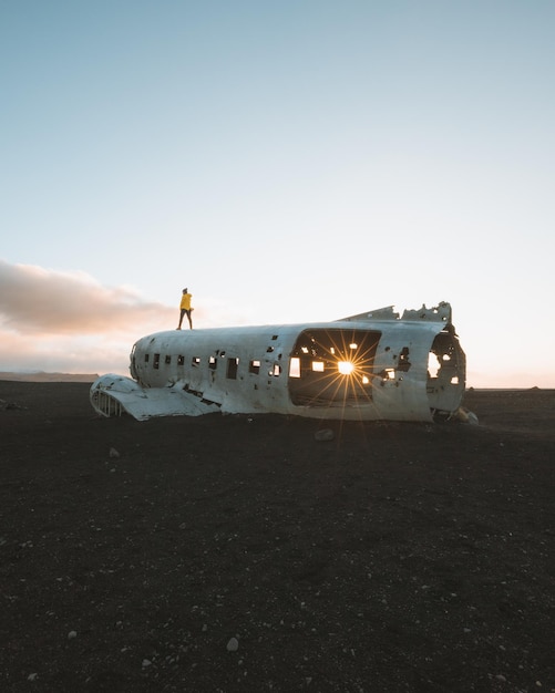 Abandoned airplane at beach against sky