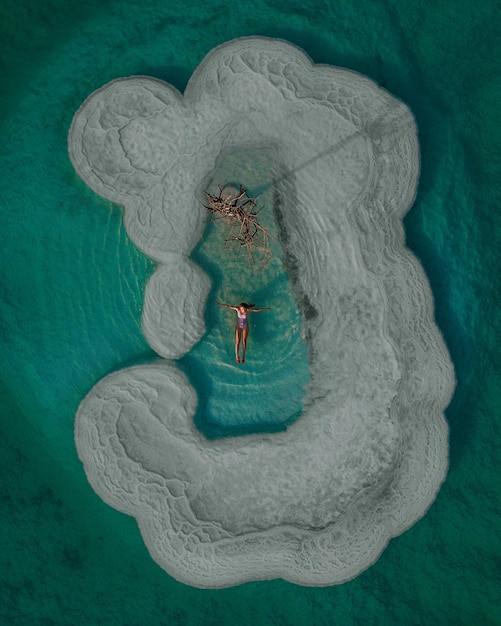 aerial view of woman floating on sea