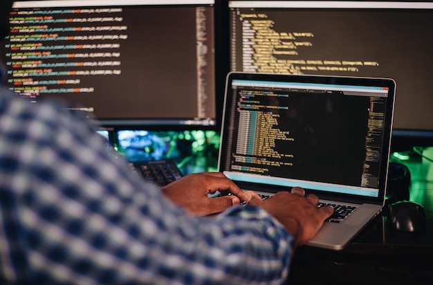 african american or black man at computer desk programming apps or web developing