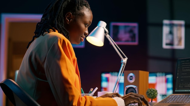 African american system engineer using AI system to write computer program code