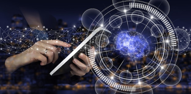 AI, Machine learning. Hand touch white tablet with digital hologram Brain sign on city dark blurred background. Digital Brain Artificial intelligence