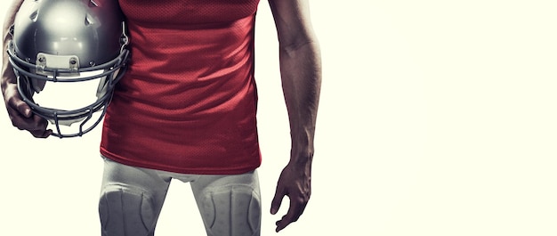 american football player holding helmet aside against white background with vignette