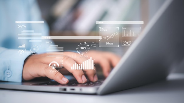 An analyst use a computer and dashboard for data business analysis and Management System with KPI metrics to the database for technology Financial data analytics Accounting record documents online