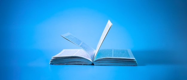 an open book on a blue background education background back to school