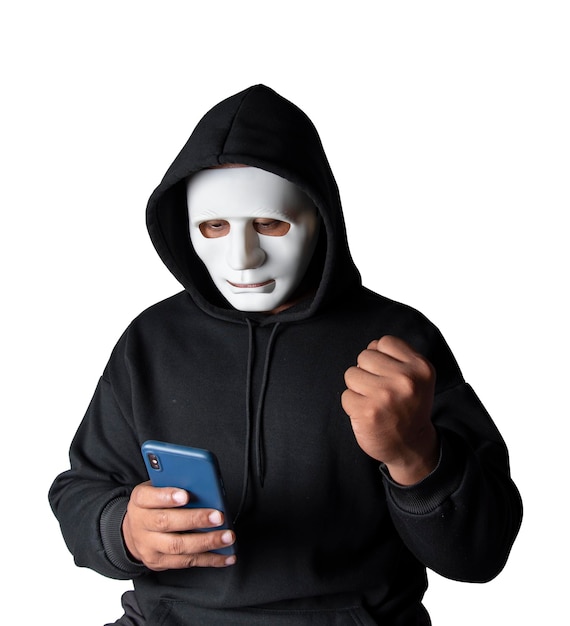 Anonymous masked hacker is using smartphones to penetrate financial data with clipping path hacking and malware concept