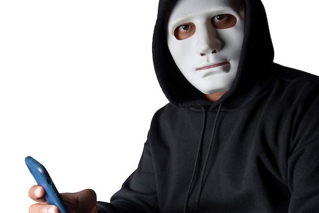 Anonymous masked hacker is using smartphones to penetrate financial data with clipping path hacking and malware concept
