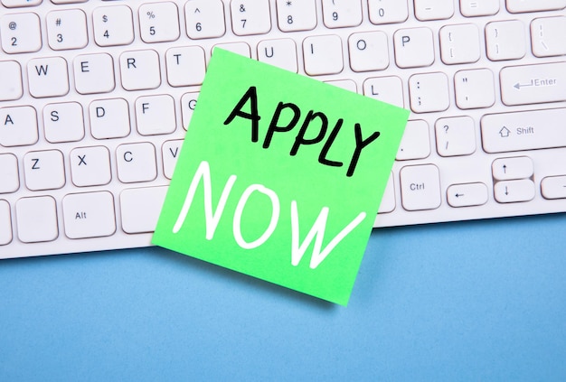 Apply now text on paper on keyboard