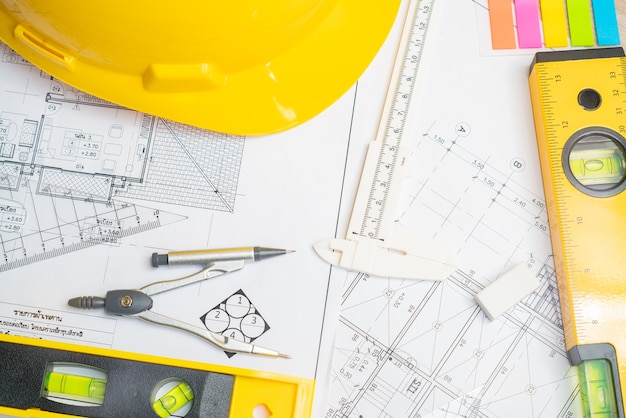 architect or planner working on drawings for construction plans at a table