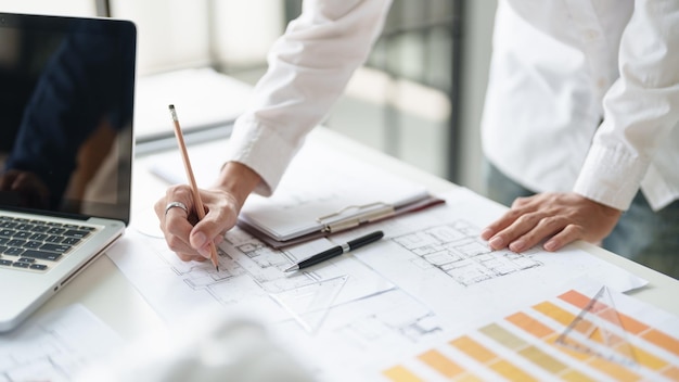 architecture drawing on architectural project business architecture building construction colleagues designer planning design on blueprint and compasses