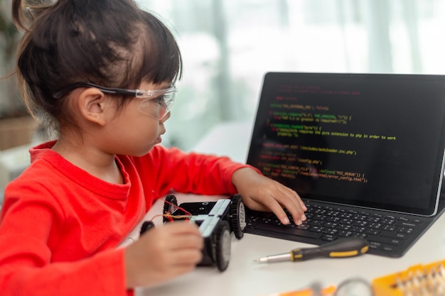 asia students learn at home in coding robot cars and electronic board cables in stem steam mathematics engineering science technology computer code in robotics for kids concept