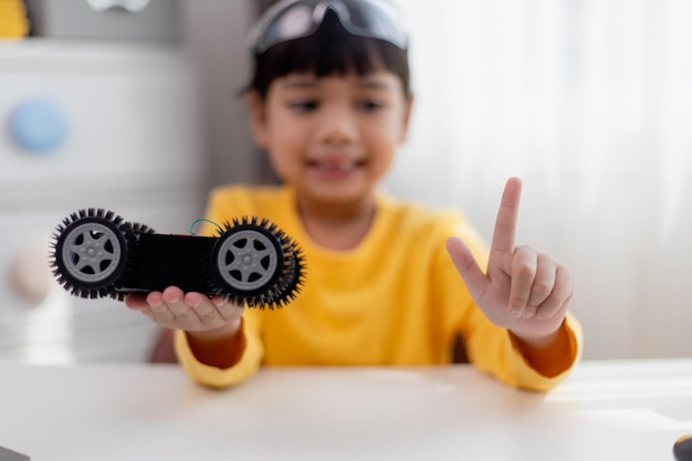 asia students learn at home in coding robot cars and electronic board cables in stem steam mathematics engineering science technology computer code in robotics for kids concept