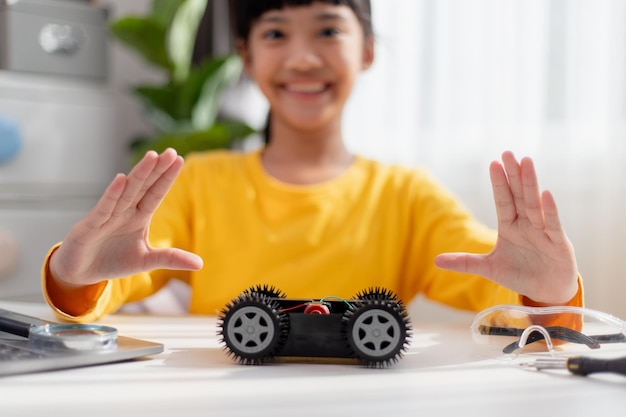Asia students learn at home in coding robot cars and electronic board cables in STEM STEAM mathematics engineering science technology computer code in robotics for kids concept