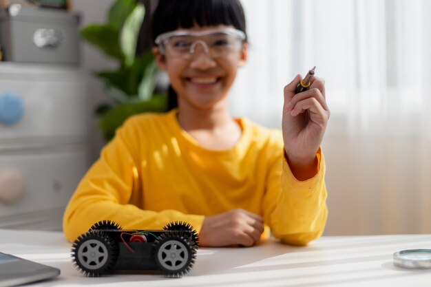 Asia students learn at home in coding robot cars and electronic board cables in STEM STEAM mathematics engineering science technology computer code in robotics for kids concept