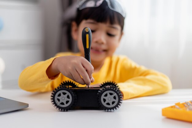 Asia students learn at home in coding robot cars and electronic board cables in STEM STEAM mathematics engineering science technology computer code in robotics for kids concept