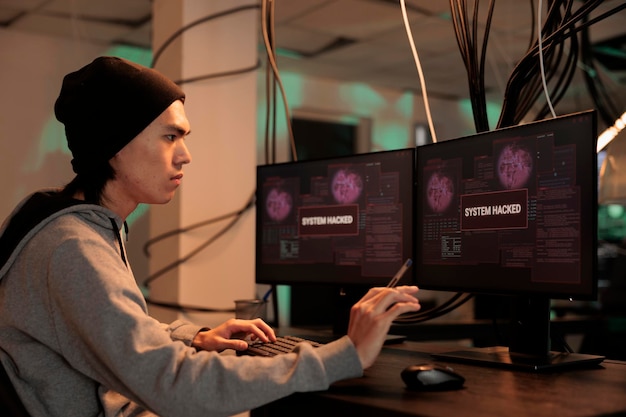 Asian hacker looking at firewall encryption to hack server