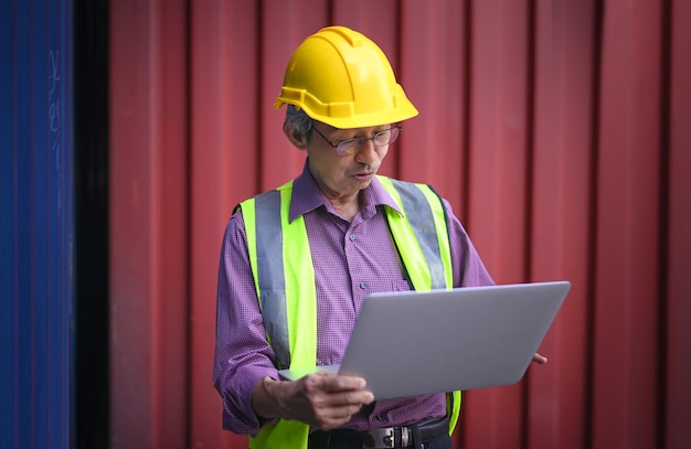 Asian man Senior Engineer worker shipment containers import export