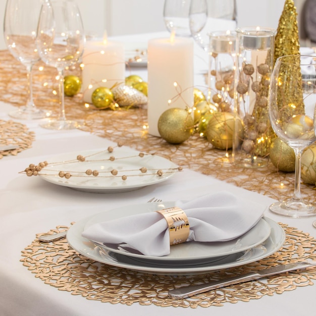 Beautiful table setting with Christmas decorations Gold colors