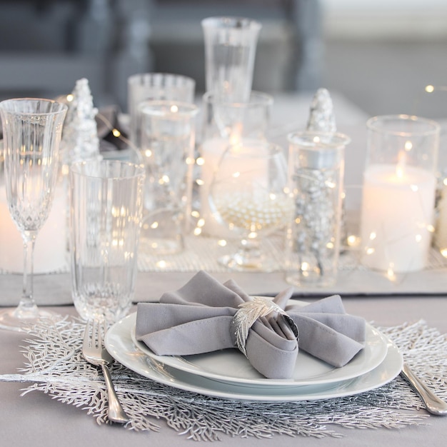 Beautiful table setting with Christmas decorations Silver colors